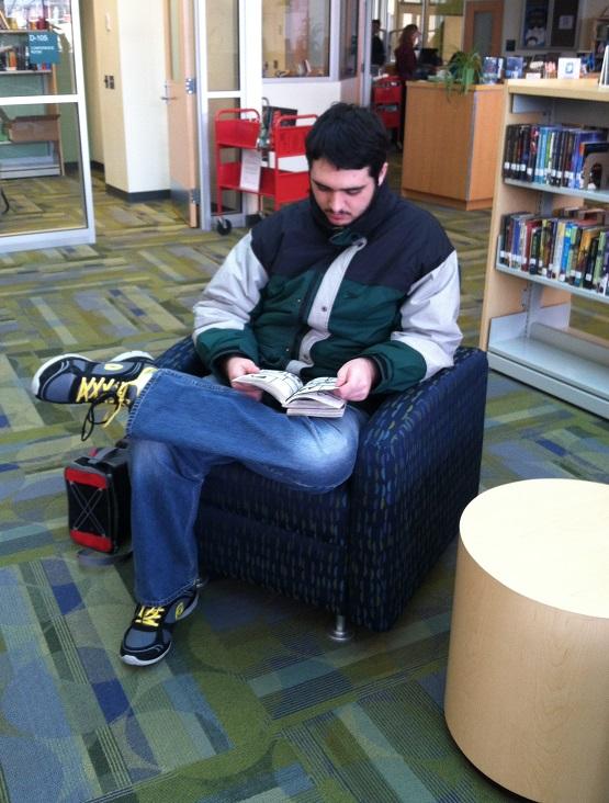 Sean Romiti-Schultze '16 kicks back in the stacks to read some Anime in the library. 