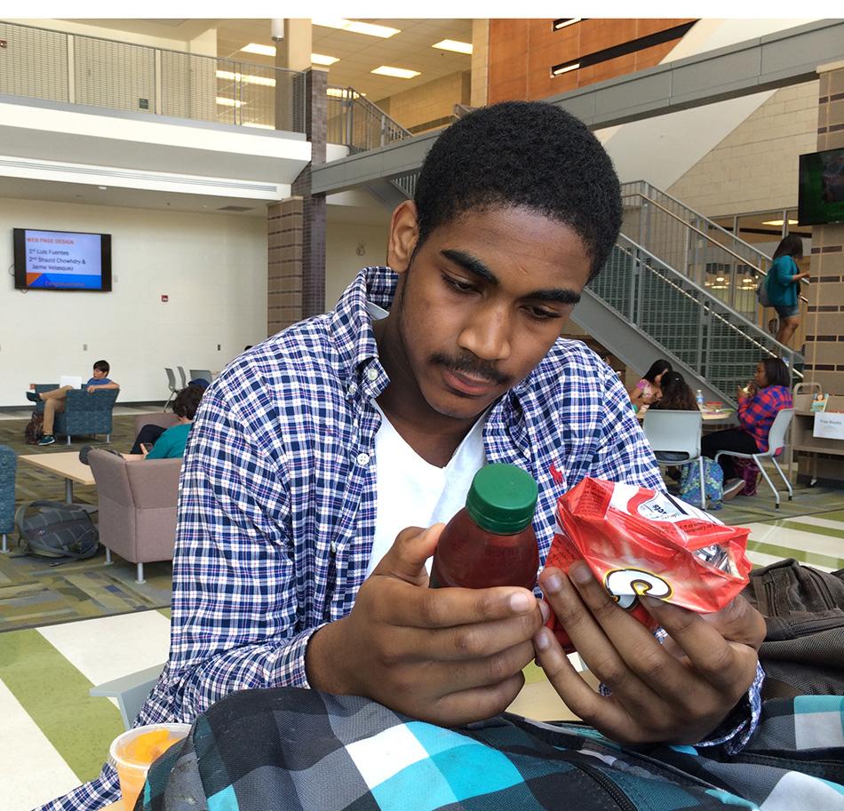 Junior Evan Ross looks at what his lunch is made of during...lunch.