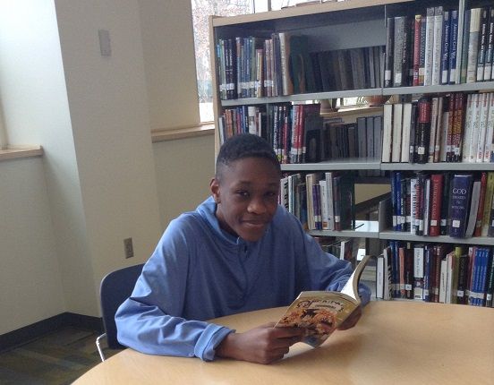 Chris Oluh '17 reads during lunch.