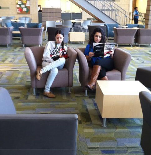 Senior Stephanie Gomez and Junior Nilofar Tokhi relax and read in Town Hall between lunches. 