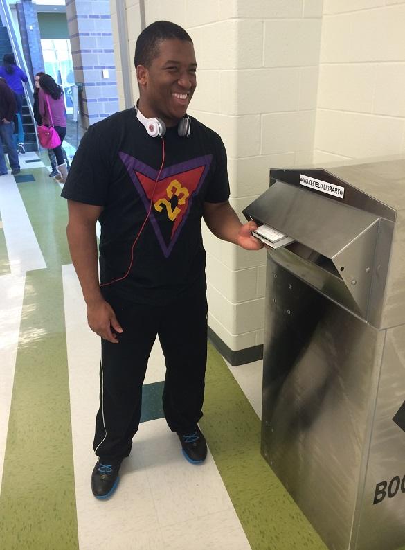 Michael Moore ’14 is one of the first students to use the book drop. 