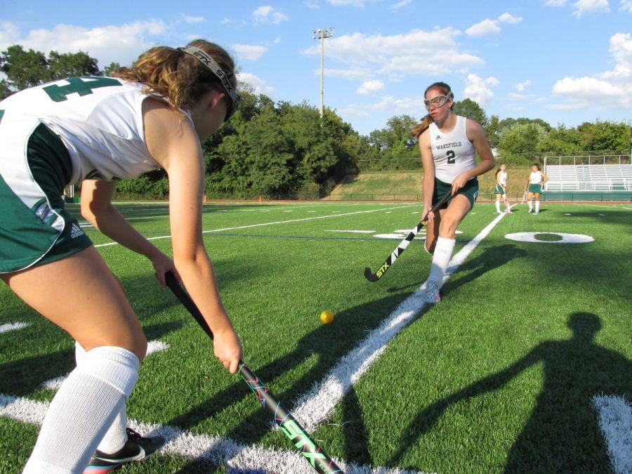 Freshman+Meghan+Anderson+and+sophomore+Liz+Tiernan+are+both+on+the+2014+JV+Field+Hockey+team.+They+warm+up+with+slap+shots+before+a+home+game.