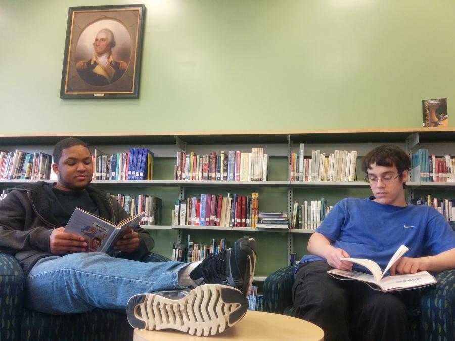 Seniors Moses Washington and Sean Kinney leisurely read in the History section of the library. 