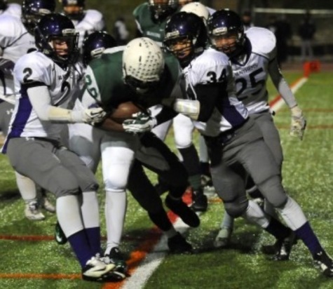 Not even three guys will stop junior fullback Kareem make a touchdown. 