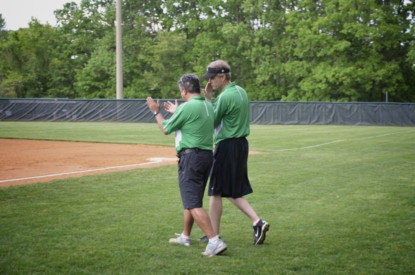 Coaches Bravo and DeFranco talk strategy as they head to the field.