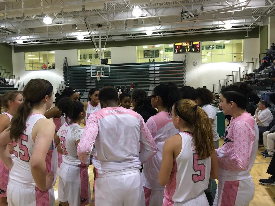 In the team huddle at the last game Olivia played on Wakefield's court. 