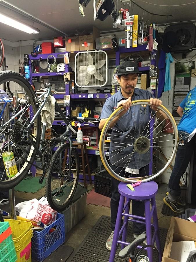A Phoenix Bikes volunteer making wheels road ready. 