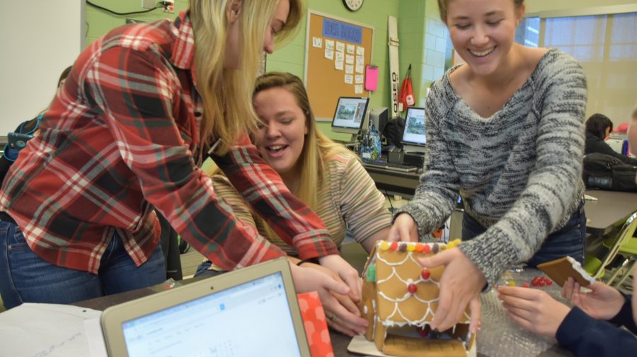 Seniors Sarah Vest, Kate Wright and Destiny Heid struggle as their gingerbread house slowly collapses. 
