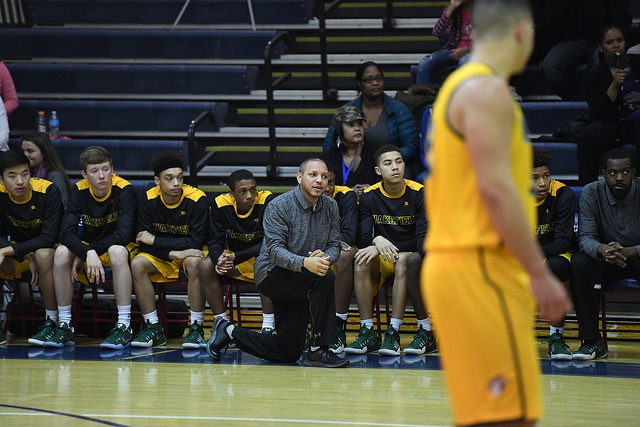 Coach Bentley yells instructions at his players on the court