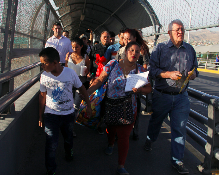 U.S. activist Ricardo Garcia (R) from Casa Asuncion shelter, accompanies six Honduran and Guatemalan migrants to ask for political asylum in the U.S. They are at the Paso del Norte International Bridge, in Ciudad Juarez Chihuahua, Mexico on the border with El Paso, Texas. This photo was taken on June 15, 2018.