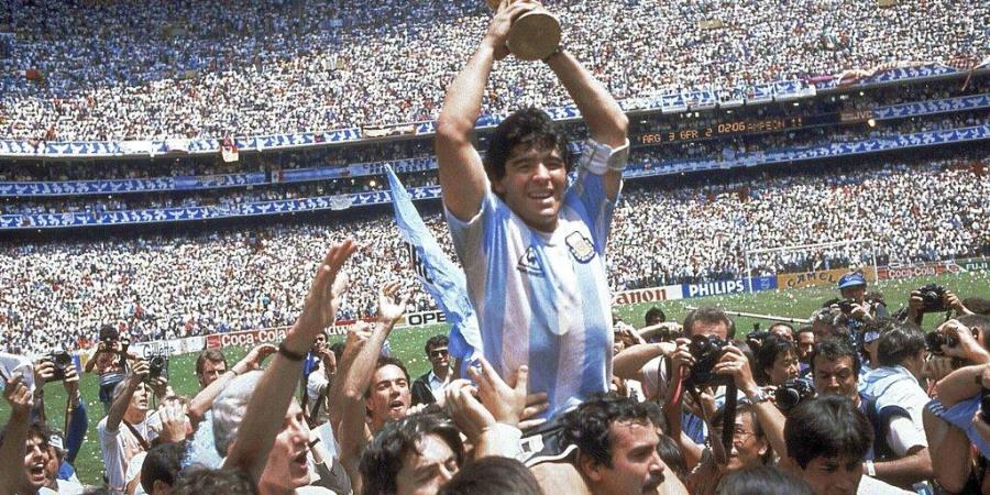 Diego Maradona holds up his teams trophy after Argentinas 3-2 victory over West Germany at the World Cup final match. (Photo | AP)